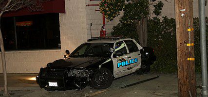 A Burbank Police Car sit against the building where it came to rest following a accident at Magnolia & Victory Friday evening. (Photo by Ross A. Benson)