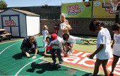 Tori Spelling looks on as her husband Dean McDermott and kids help put installing the new playground matts, at Burbank Boys & Girls Club. (Photo by Ross A. Benson]