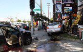 Accident causes cars to come to rest in doorway of Art-Wave Warehouse at Alameda Ave & Victory Blvd Friday afternoon. (Photo by Ross A. Benson)