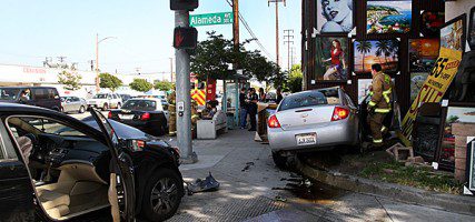 Accident causes cars to come to rest in doorway of Art-Wave Warehouse at Alameda Ave & Victory Blvd Friday afternoon. (Photo by Ross A. Benson)