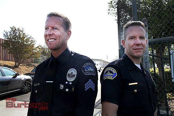 Sgt Darin Ryburn with new badge and shoulder patch, Officer David Hardy with old shoulder patch. (Photo by Ross A. Benson)