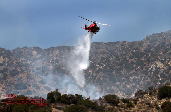 Los Angles City Copter 5 makes a water drop on a hotspot during a small brush fire that occurred above DeBell hole 16. (Photo by Ross A. Benson)