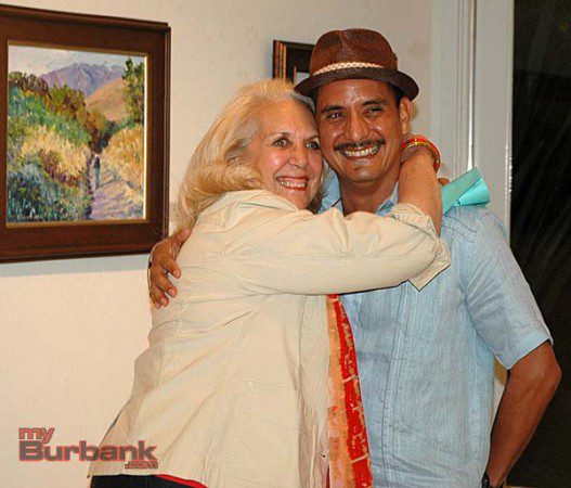 Best of Show winner Kaaren de Gorricho hugs exhibition chairman Ricardo Cerezo during the opening reception for the San Fernando Valley Art Club show on Friday night at the Burbank Creative Arts Center Gallery. (Photo by Joyce Rudolph)