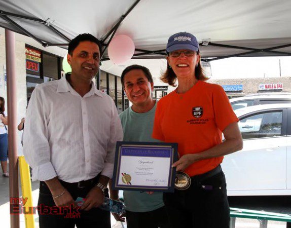 Burbank Mayor Emily Gabal Luddy presents a Certificate of Recognition to Yogurtland owner and the shopping center owner at Saturday's Grand Opening. (Photo by Ross A. Benson)