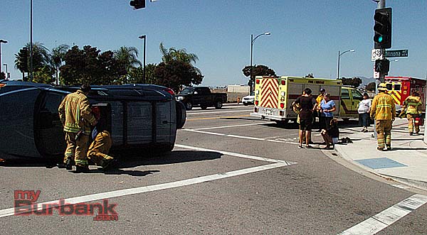 Firefighters check out a car after assisting victims out of the vehicle (Photo By Nick Colbert)