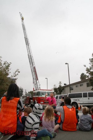 Firefighter Donan climbs to the very top of the tall ladder. (Photo By Ross A. Benson)