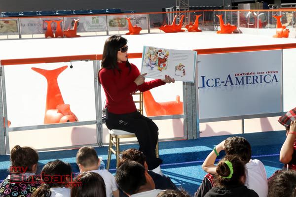 Olympian Kristi Yamaguchi reads from her book "It's a big world, little pig!" during her visit at  The Rink on Wednesday. (Photo by Ross A. Benson)