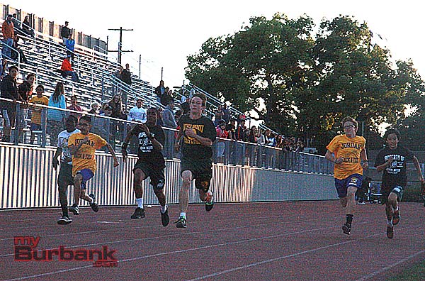 Julian Read of Luther Burbank (center) sprints his way into the record books in the 100 meter dash (Photo by Dick Dornan)
