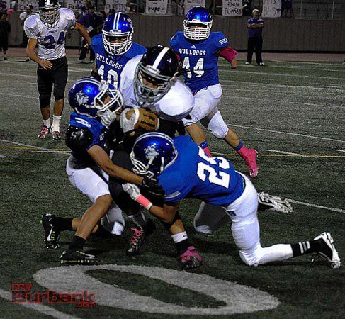 The Bulldogs "D" put the squeeze on the Tornadoes (Photo by Craig Sherwood)