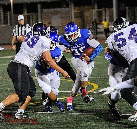 Kyle Alvarez plows his way for yardage against Hoover (Photo by Craig Sherwood)