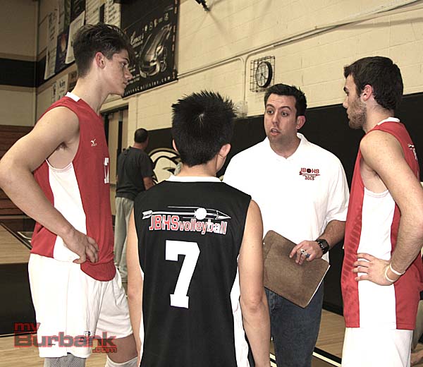 Coach Joel Brinton speaks to his team prior to the pivotal third set (Photo by Dick Dornan)