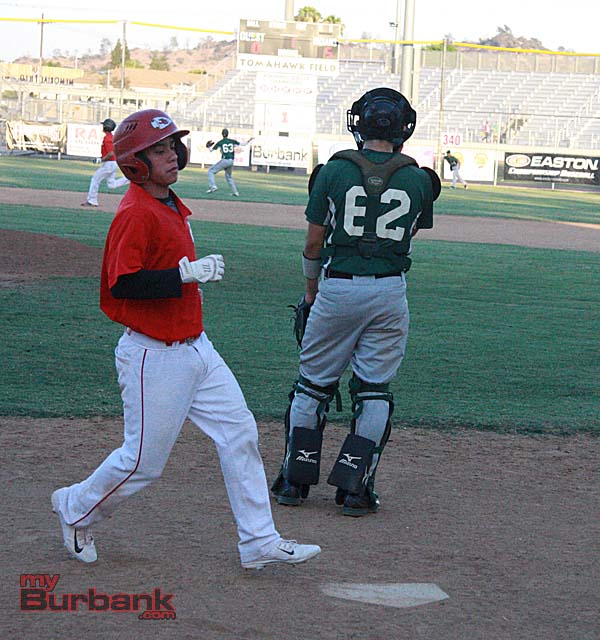 Alec Saavedra scores for Burroughs after doubling in three runs (Photo by Dick Dornan)