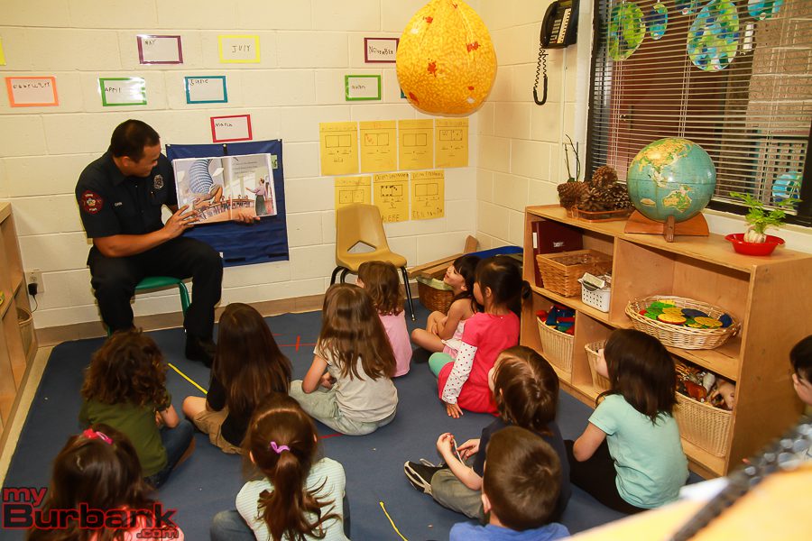 Burbank Fire Fighter Justin Chin read during Read Across America at The Burbank YMCA.  (Photo by © Ross A. Benson)