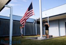 Greg Madore Leads His Son in Caring for the U.S. Flag to Honor Veterans at Horace Mann Child Development Center