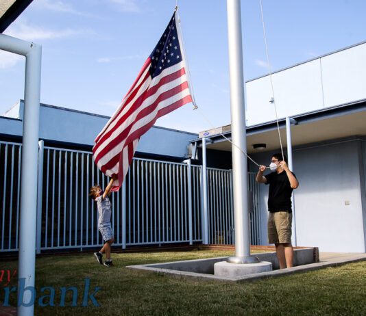Greg Madore Leads His Son in Caring for the U.S. Flag to Honor Veterans at Horace Mann Child Development Center