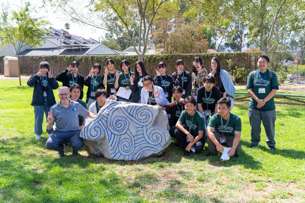 Students from Japan's Rebun Island and teacher Ted DeVirgilis pose with the Muir Peace Monument at John Muir Middle School's twelfth annual Japan Day. (Photo Courtesy Kentaro Terra)