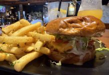 Magnolia Corner Opens With Revamped Space, Solid Bar Menu Magnolia Corner's Classic Beef Cheeseburger is topped with cheddar cheese, cocktail sauce, tzatziki, grilled onions, lettuce and tomato and accompanied by fries seasoned with parsley, salt and pepper.