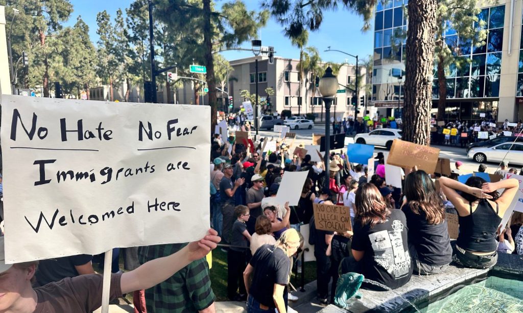 Students from Providence High School hold up a sign at a protest that reads, "No Hate, No Fear, Immigrants are Welcome Here