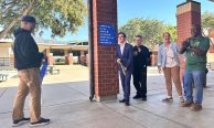 Burbank High Students Lead Wayfinding Project to Make Campus Safer and More Welcoming Two students and three school officials smile as they use large scissors to cut a ribbon in front of a new campus wayfinding sign at Burbank High School.
